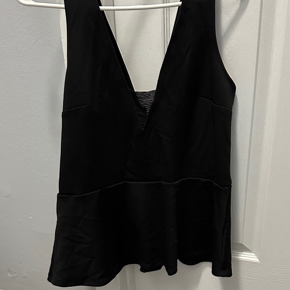 Black peplum going out top